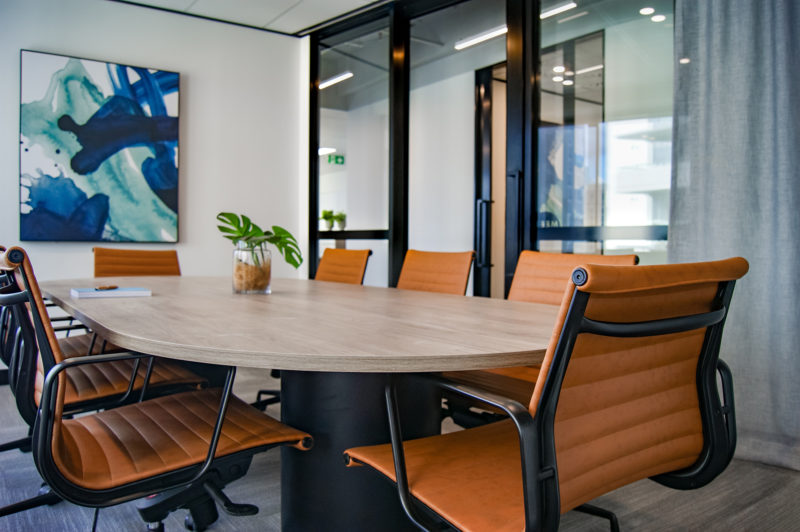 orange chairs around small table in conference room